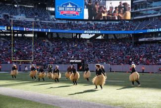 Young women perform African dance at MetLife Stadium