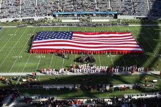 A giant American flag on a football field