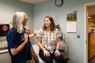 Student speaks with a nurse