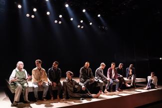 men on stage in a Broadway show