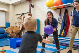 Physical therapy students work with children
