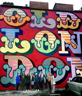 London Center students at Shoreditch in front of street art by Ben Eine.