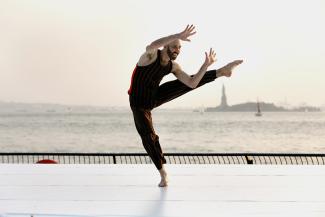 dancer in front of statue of liberty