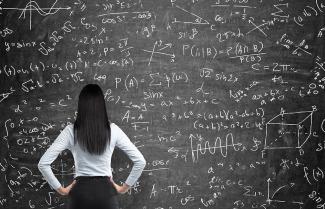 Woman Standing at Chalkboard