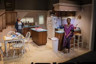 two women in a kitchen in a play