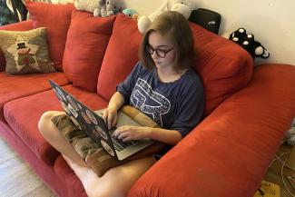student on a laptop on a couch