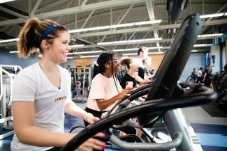 students on exercise equipment in the Fitness Center