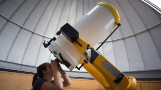 Amy Parker looks through the telescope at the Ford Observatory.
