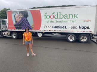 female student in front of Food Bank truck