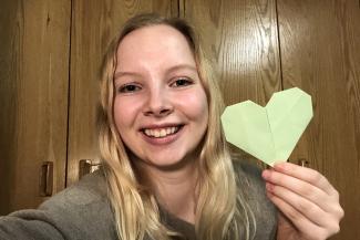 Eleanor Kay ’23 holding an origami heart
