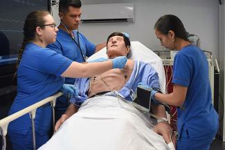 students with patient care manikin