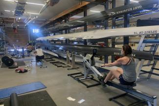 rowers in a boathouse on ergs
