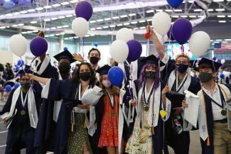 masked graduates celebrate at commencement