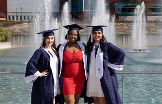 Seniors in front of the fountains with caps and gowns