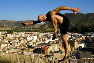 A self-portrait of Daniel Gwirtzman dancing on a ledge in Spain.