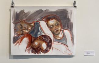 A photo of Julia's painting showing three people laying down