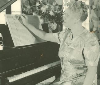 woman seated at piano