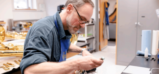 Neil Adams repairs an instrument