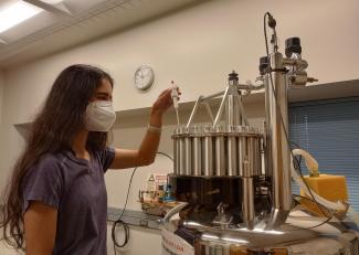 Student using a Nuclear Magnetic Resonance maching