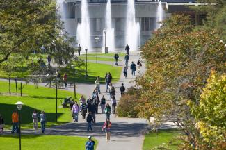 Students walking on Quad with fountains.