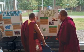 Monks in front of posters