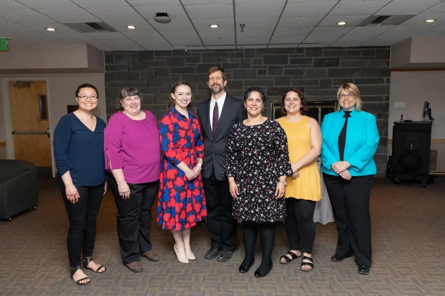 Seven people standing in a row for a photo
