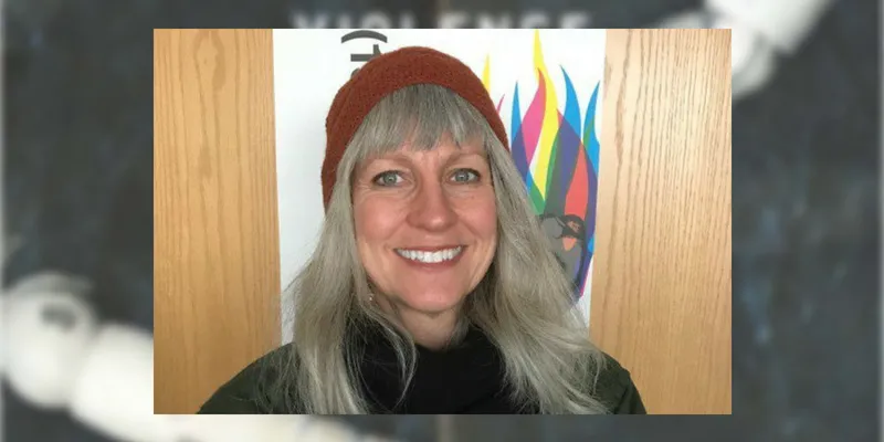 A woman poses with a smile. 