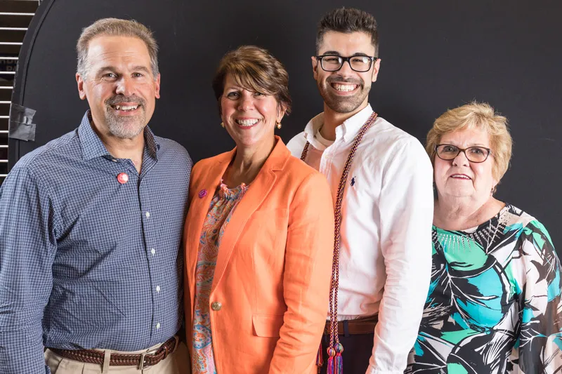 Four family members pose together. 