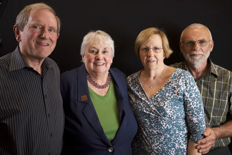 Four individuals pose together. 