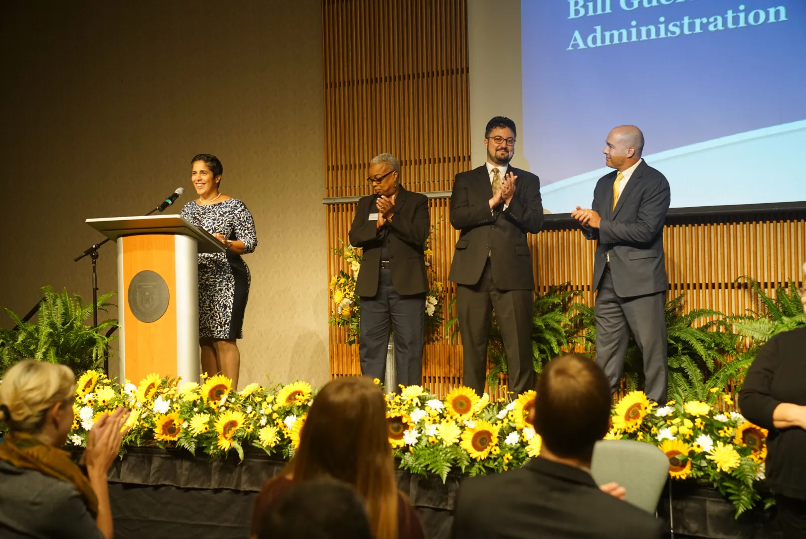 Four people standing on stage