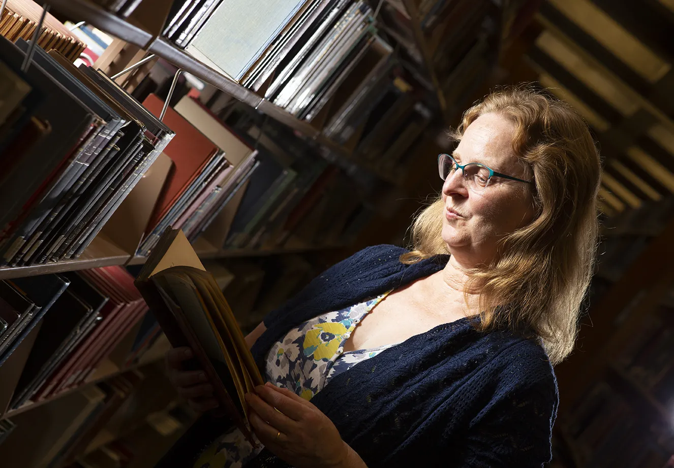 Katharine Kittredge does research in a library