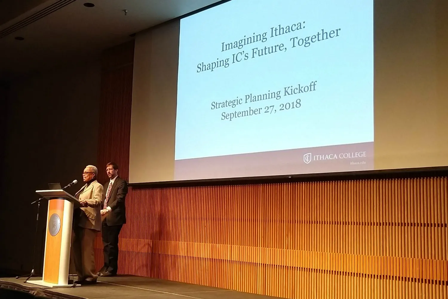 Two people standing on stage