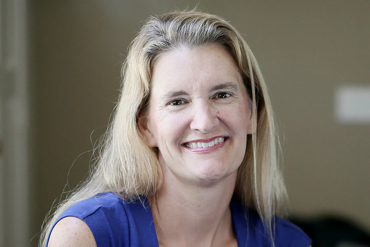 A blonde-haired woman smiling