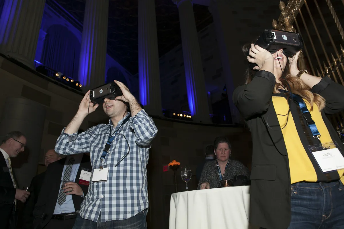 Two people wearing virtual reality goggles