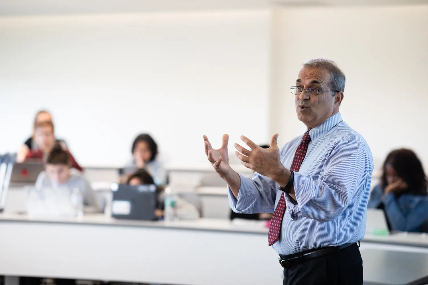 Professor teaching in front of a class of college students