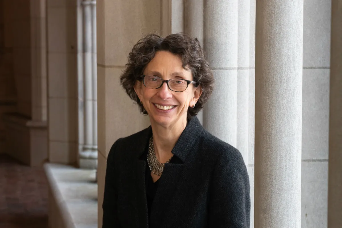 A woman in front of columns