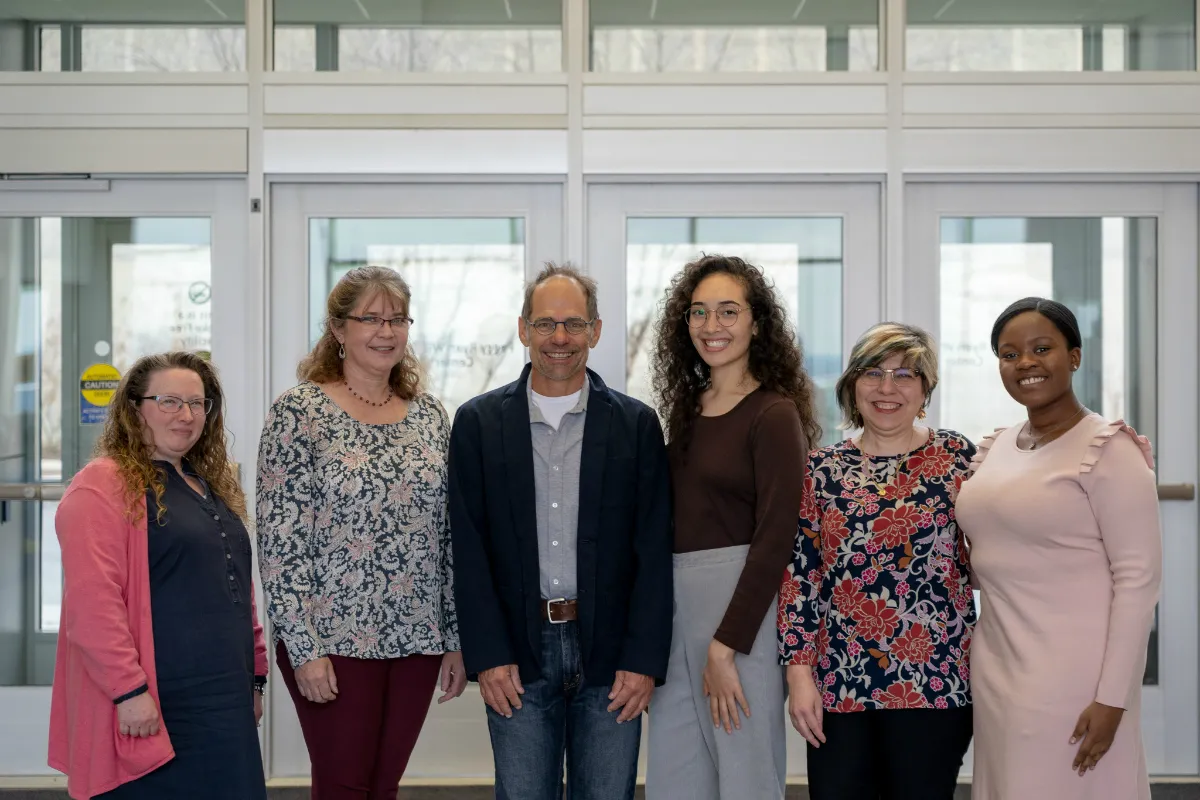 A group of six men and women posing for a photo