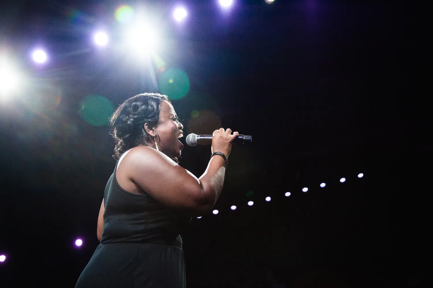 A woman singing into a microphone