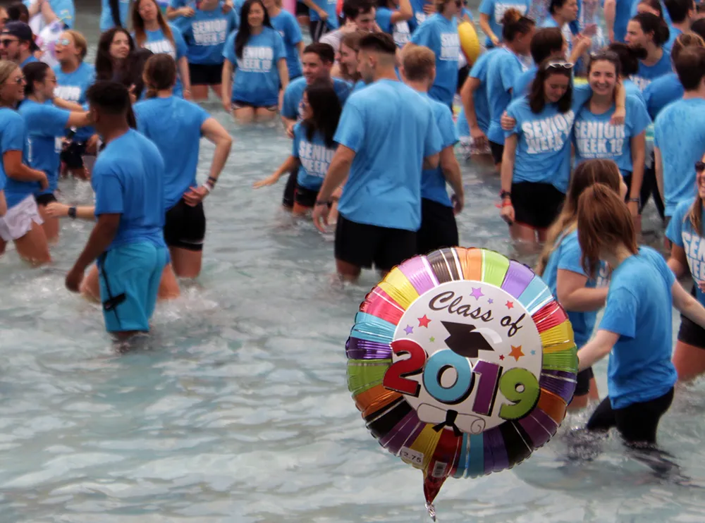 people in the fountain with a balloon that says Class of 2019