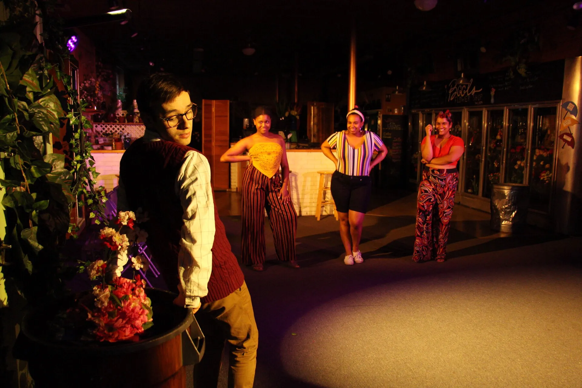 Four performers in a flower shop