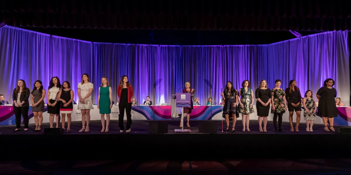 A group of women standing on stage