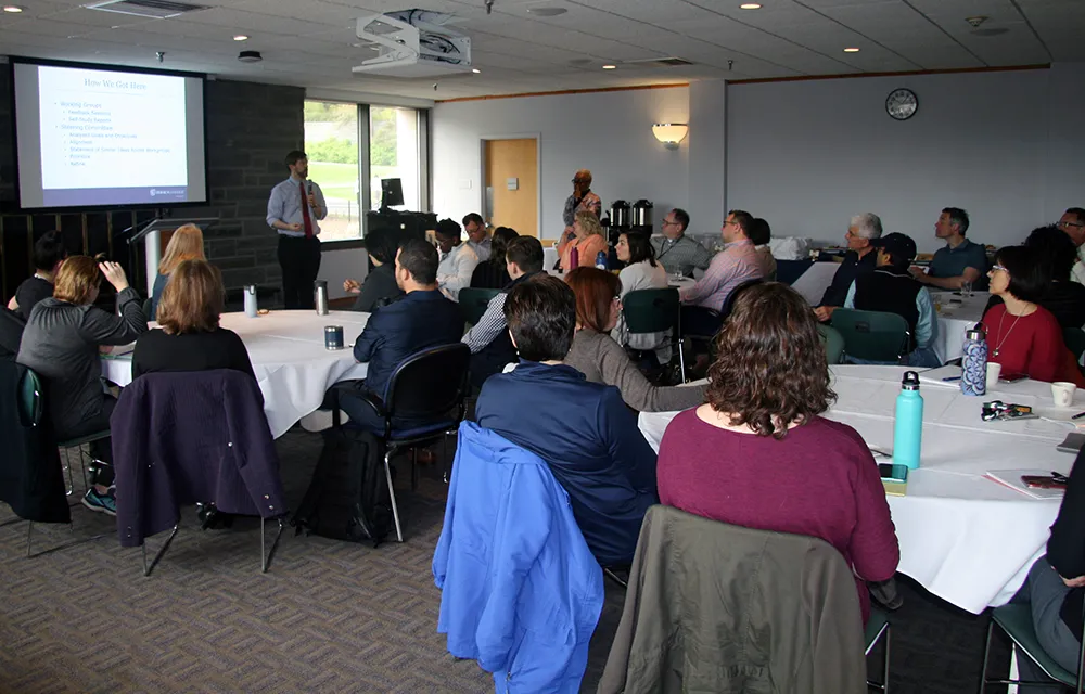 People sitting listening to a speaker