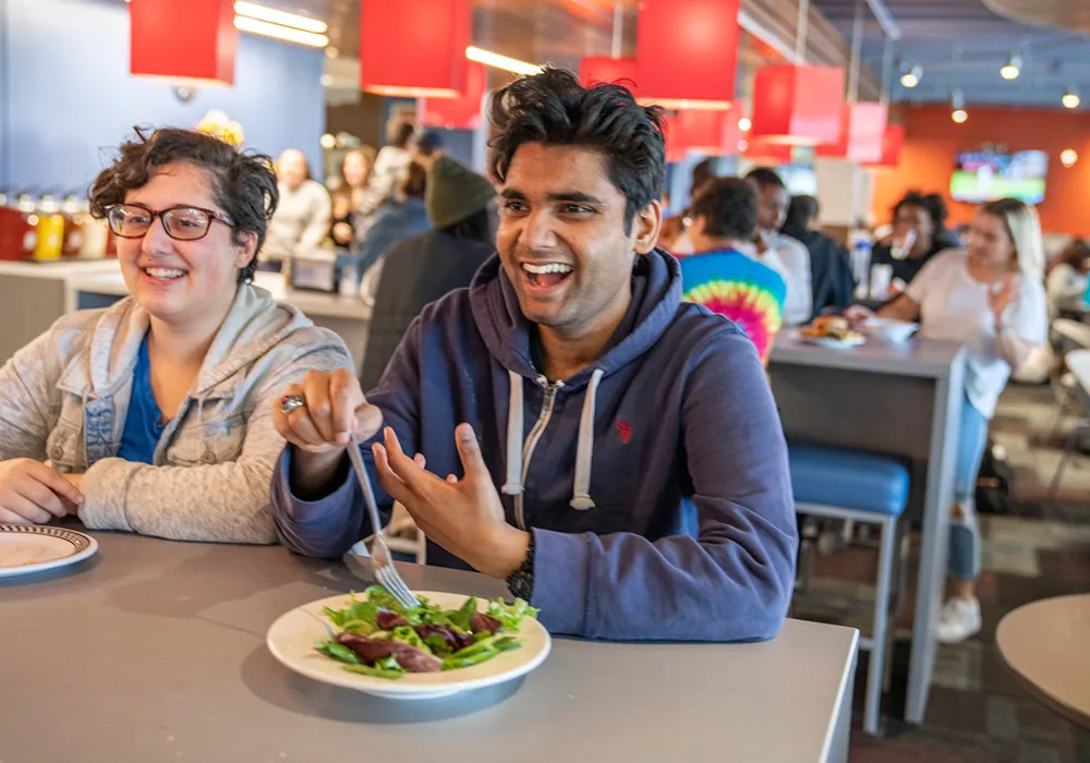 Two young people sitting at a restaurant table
