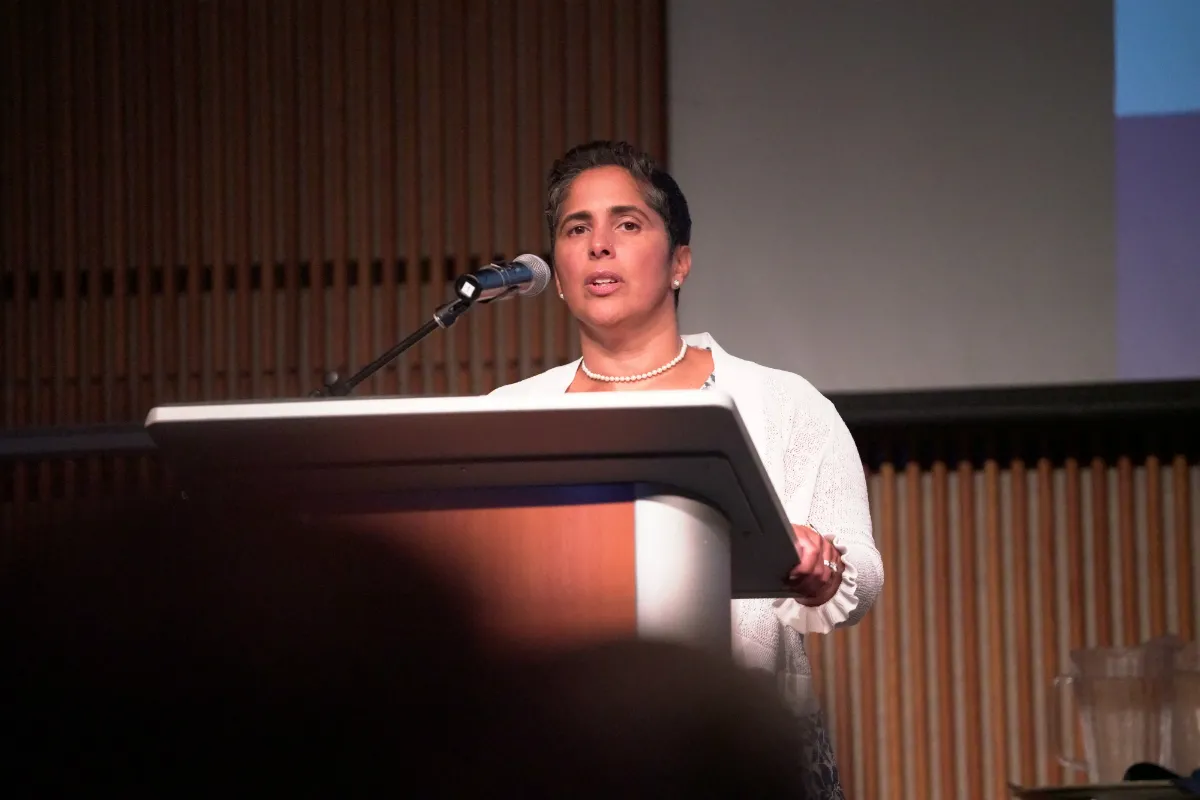 A woman speaking at a podium