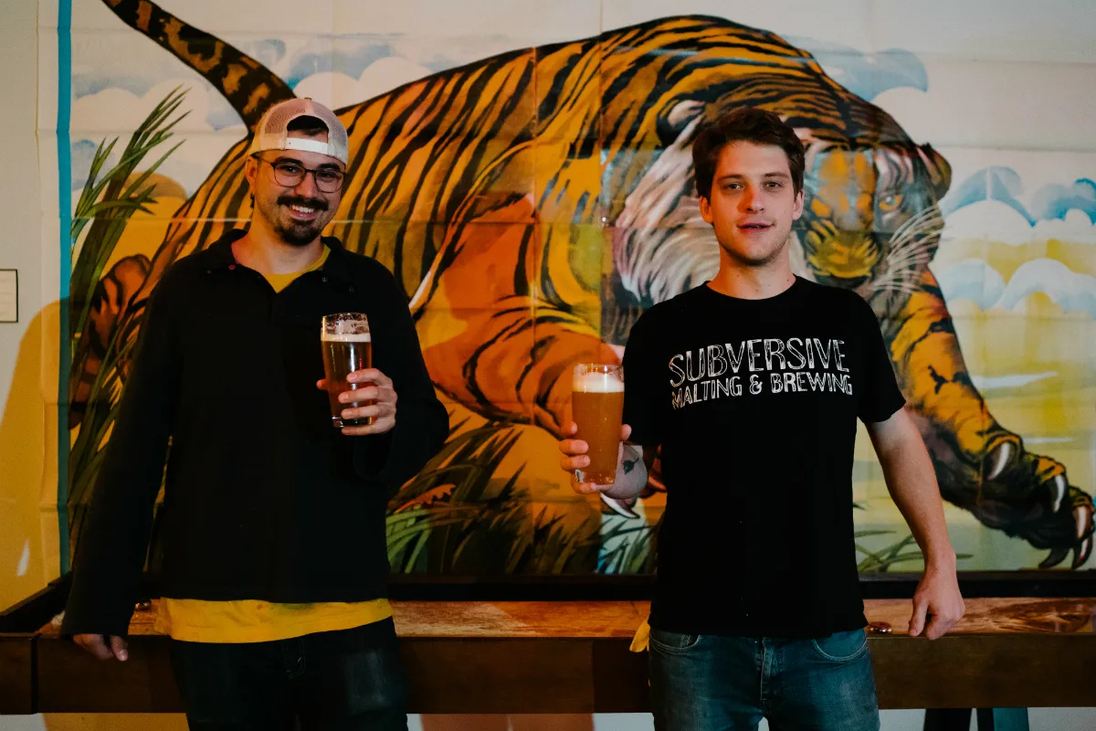 Two men holding pints of beer