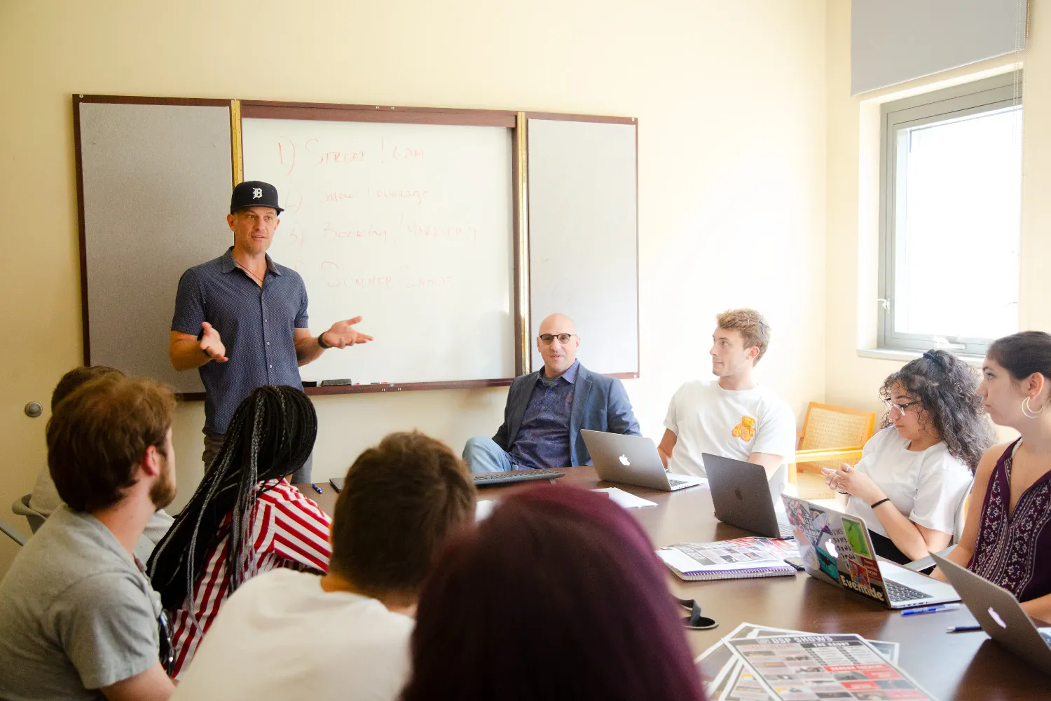 A man lectures to a small class of people