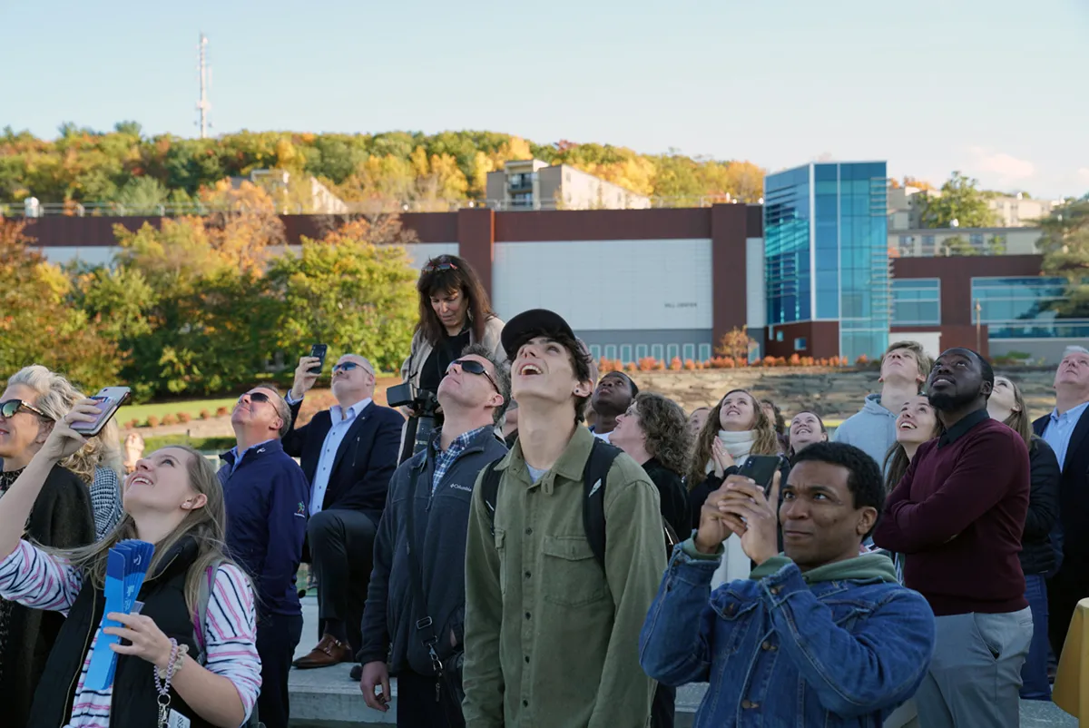 people watch a rocket in the sky