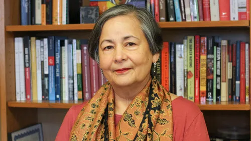 woman in front of bookshelf