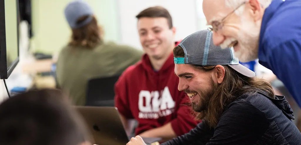Professor John Barr works with students in class