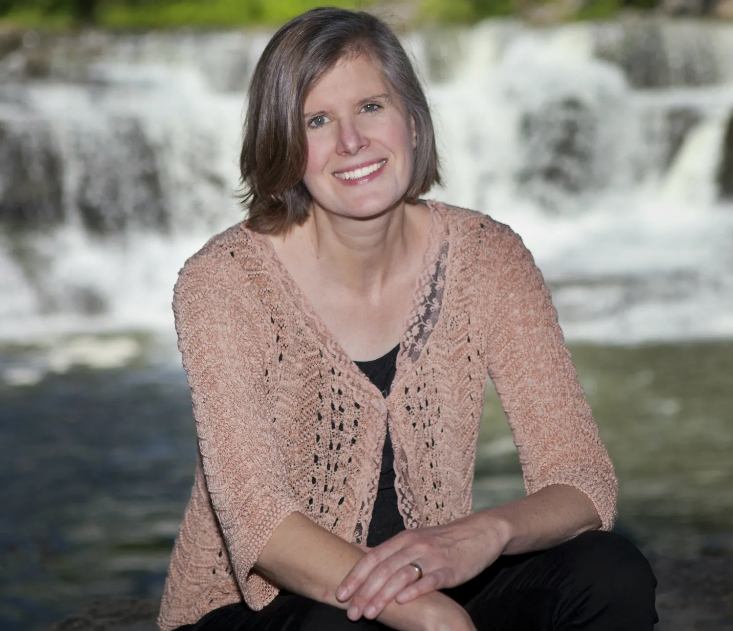 woman in front of waterfall